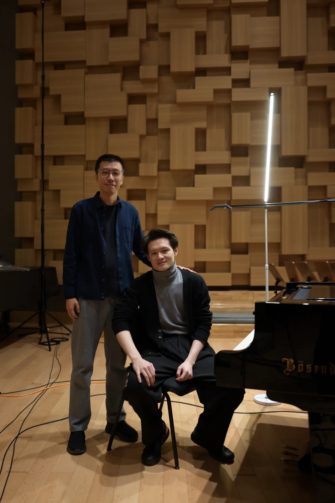 Zhang Yilong (left) and pianist Xiaofu Ju (right) beside the Bösendorfer piano.